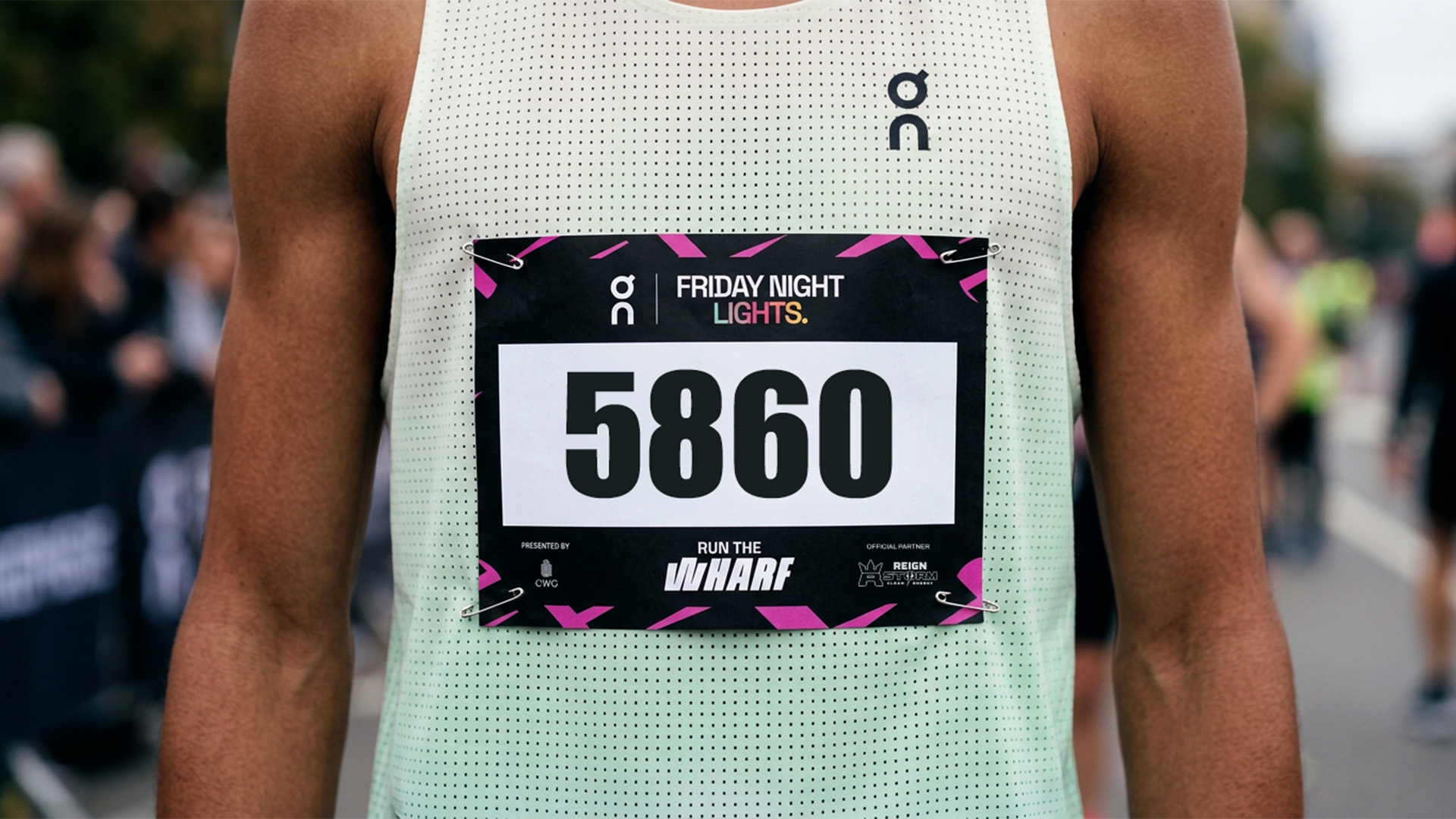On Running Friday Night Lights race bib featuring the Run the Wharf identity
