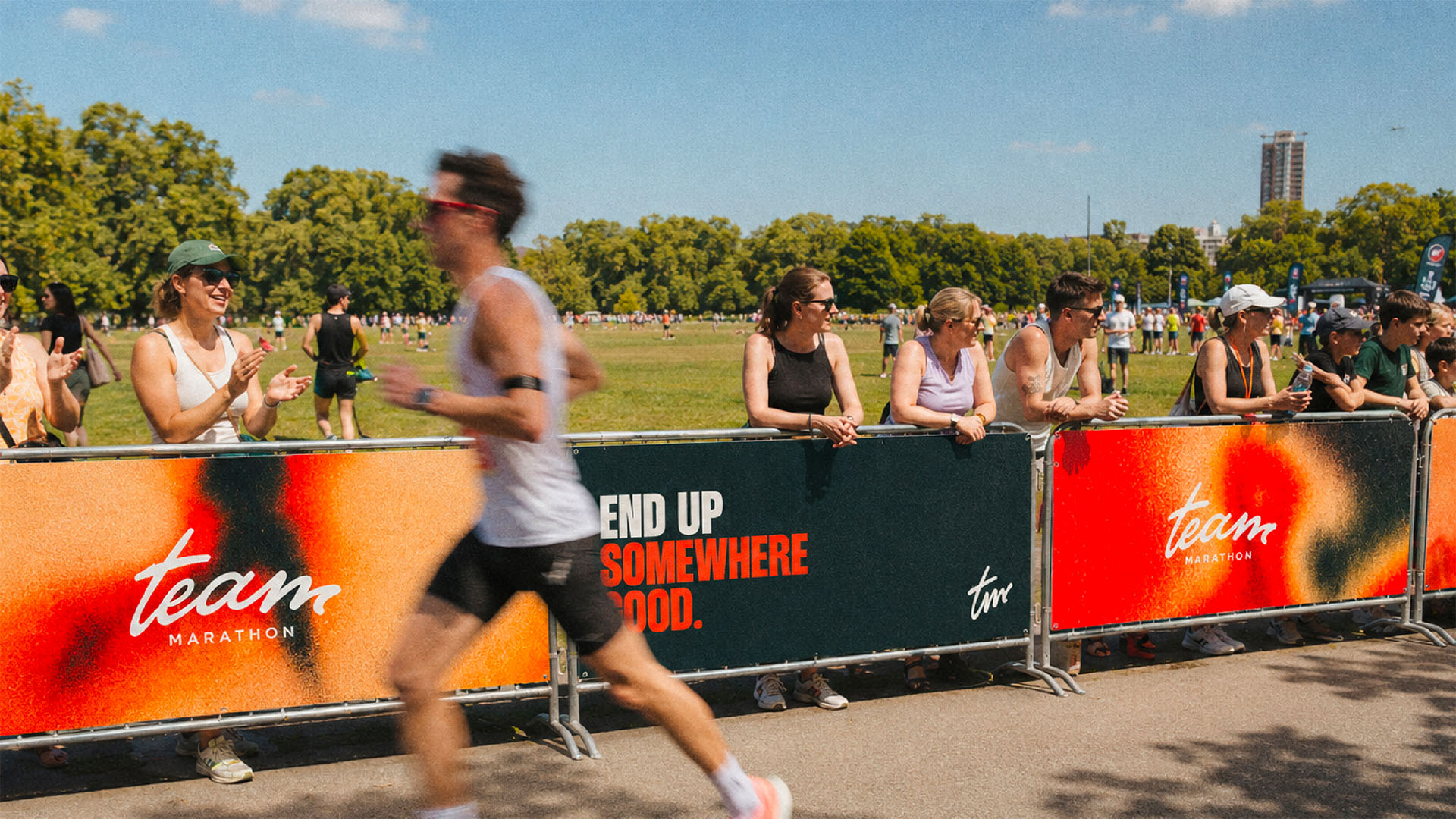 Team Marathon race branding shown beside a runner and spectators